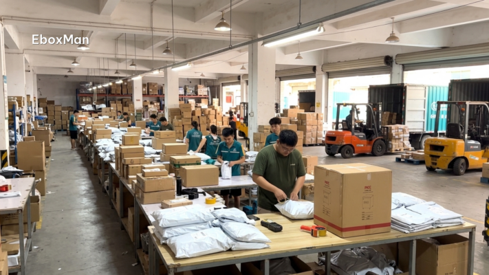 Chinese warehouse staff packing parcels for shipment