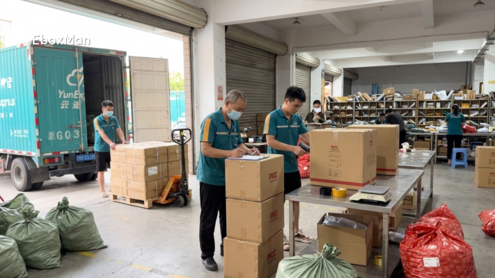 Warehouse staff inspecting boxes before shipment loading