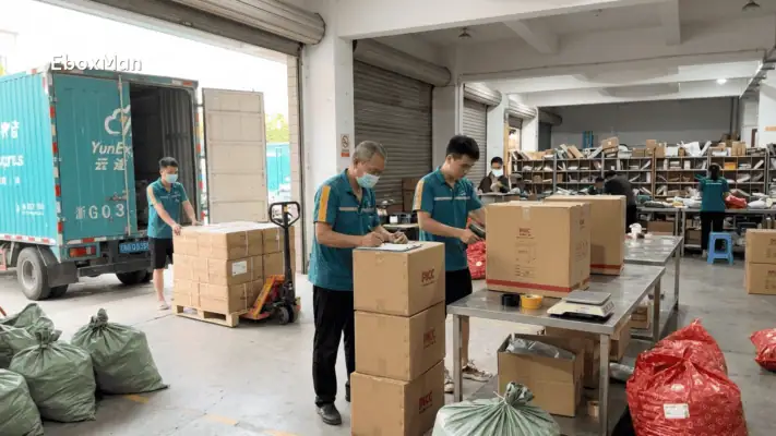 Warehouse staff inspecting boxes before shipment loading