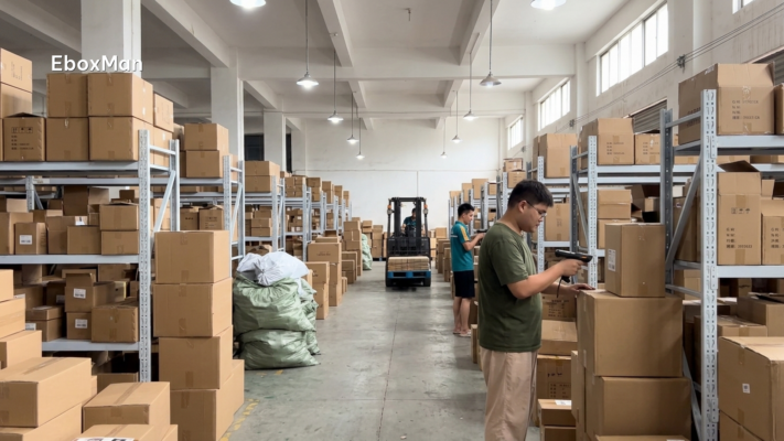 Chinese fulfillment warehouse workers scanning inventory on shelves