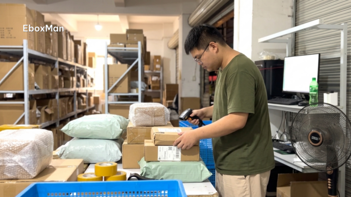 Warehouse worker scanning parcels before dispatch