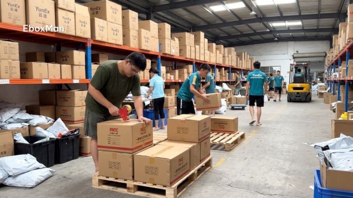 Chinese warehouse workers palletizing boxes for a consolidated shipment