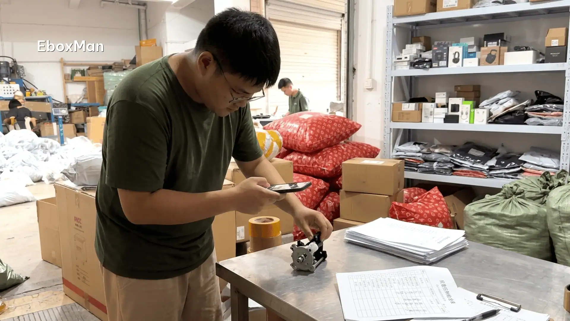 QC inspector photographing a product batch before dispatch
