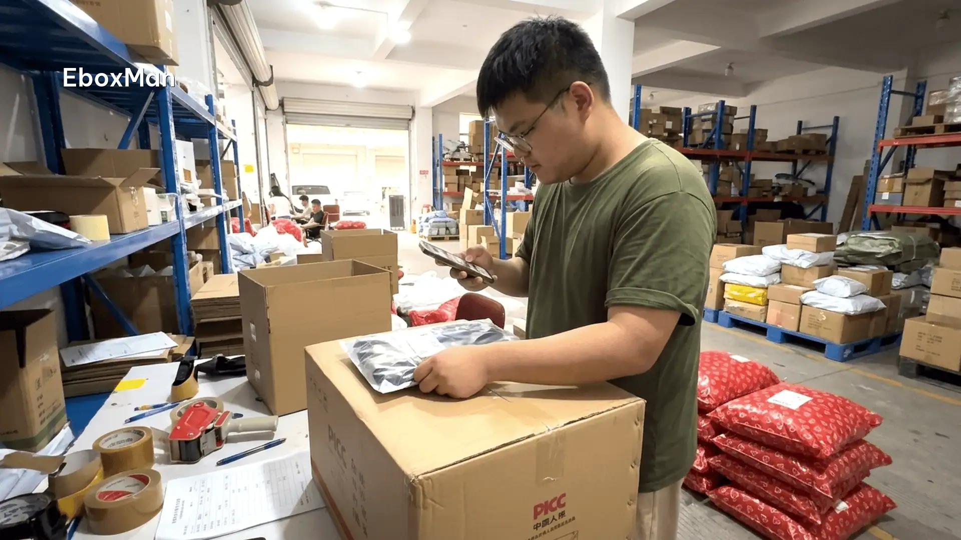 QC staff photographing a product batch before dispatch