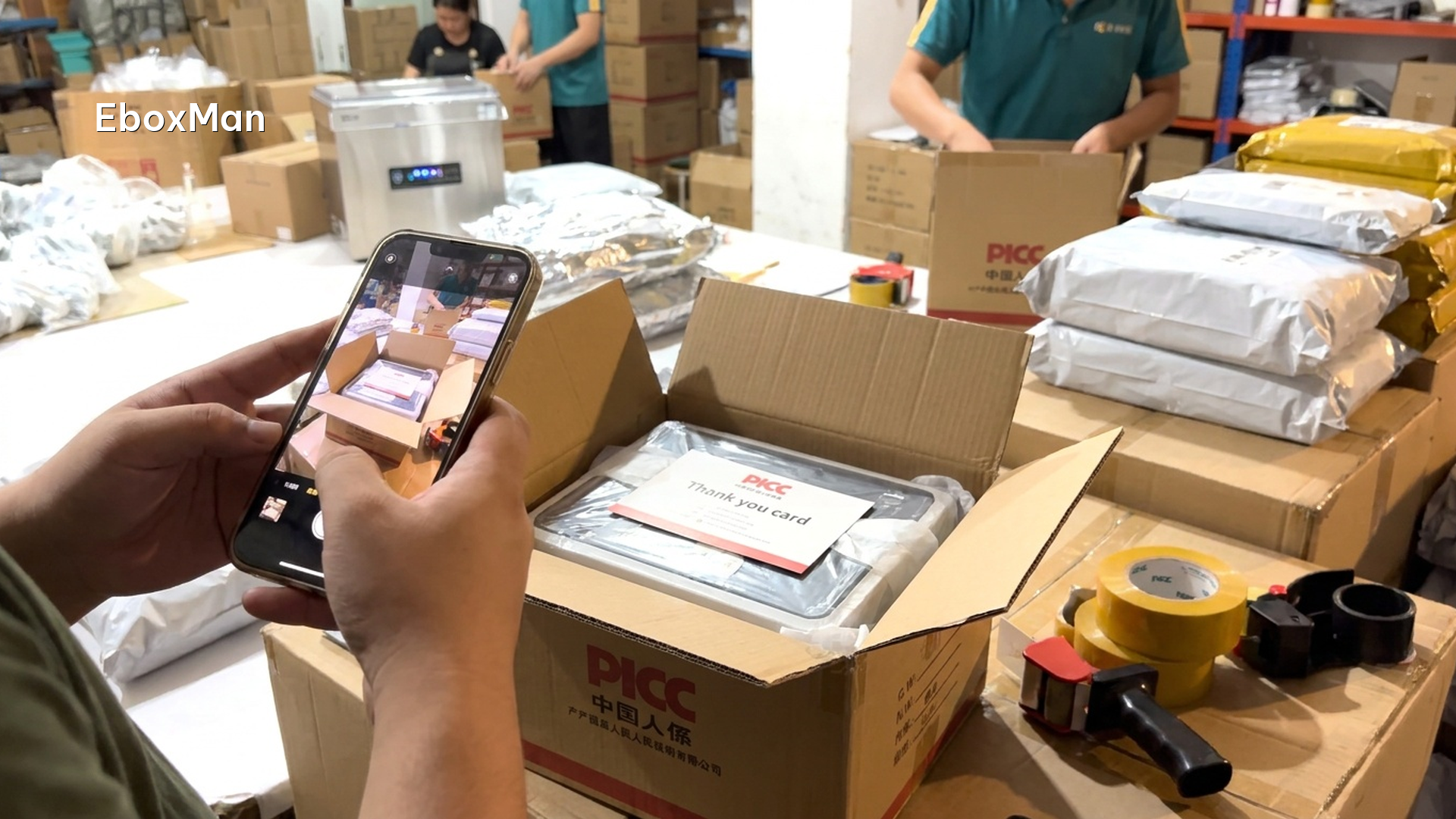 QC desk photographing a branded unboxing package before shipment