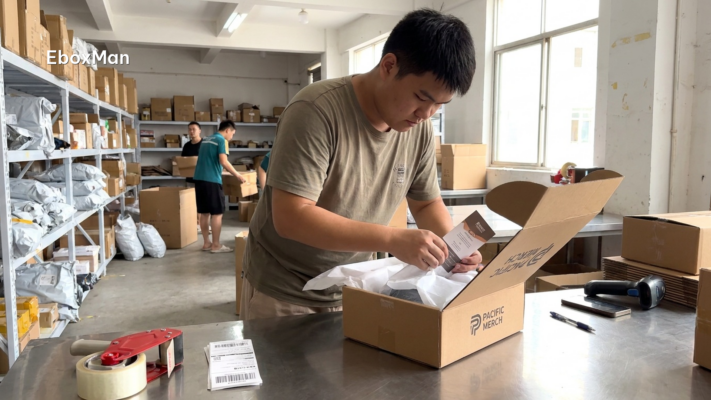 Warehouse worker packing custom branded packaging for a dropshipping order