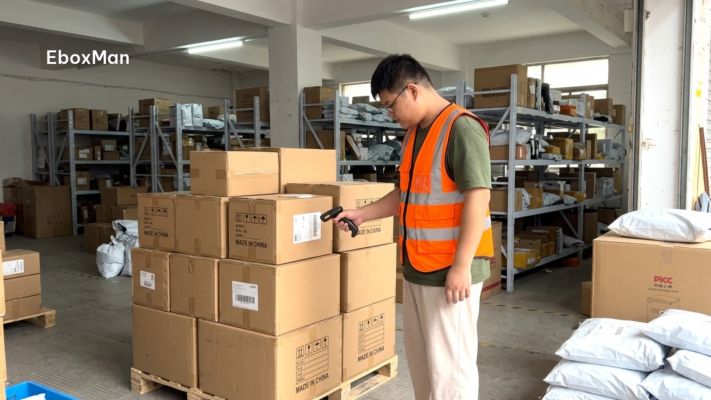 Warehouse worker scanning export parcels in a Chinese fulfillment facility