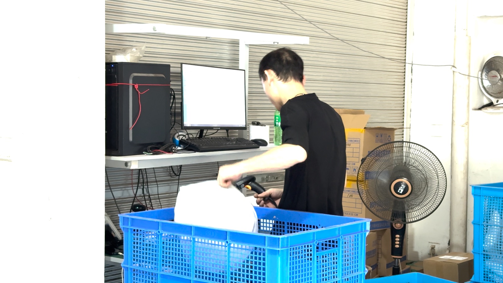 Warehouse worker scanning a parcel barcode before dispatch